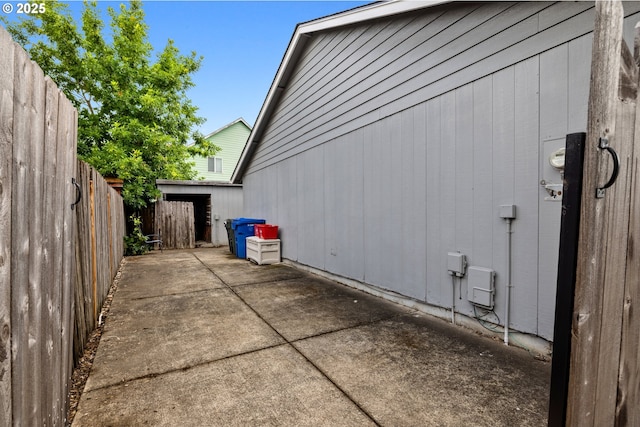 4931 NE Mink Ct, Salem, OR 97305 - view of home's exterior featuring a fenced backyard and a patio area