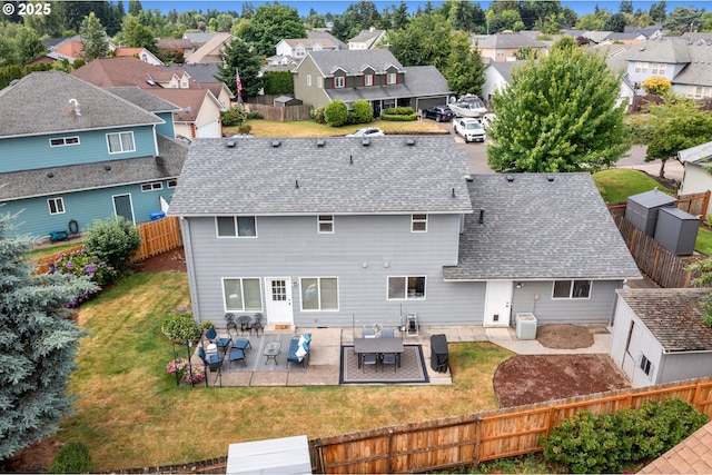 4931 NE Mink Ct, Salem, OR 97305 - rear view of property with a residential view, roof with shingles, a fenced backyard, and a patio area