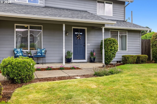 4931 NE Mink Ct, Salem, OR 97305 - view of exterior entry with a porch, roof with shingles, and a lawn