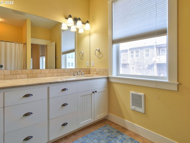 bathroom with vanity, tile patterned flooring, and heating unit