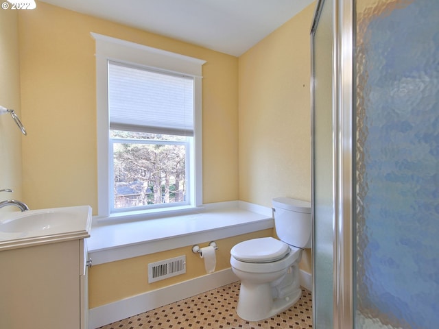 bathroom with vanity, a shower, and toilet