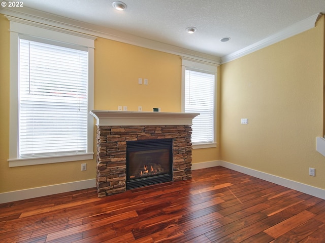 unfurnished living room with ornamental molding, dark wood-type flooring, and a fireplace