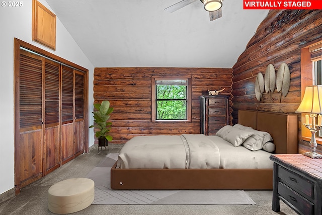 bedroom with carpet floors, log walls, and vaulted ceiling