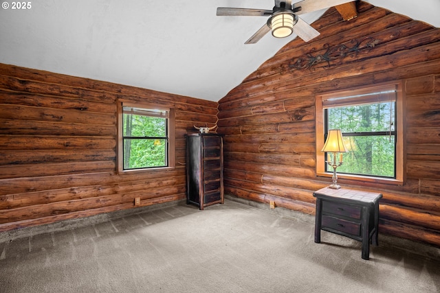 unfurnished bedroom with a ceiling fan, carpet, multiple windows, and lofted ceiling