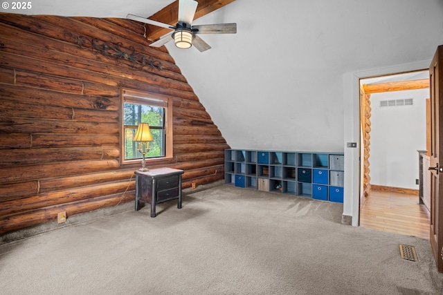 additional living space with log walls, ceiling fan, carpet, and vaulted ceiling