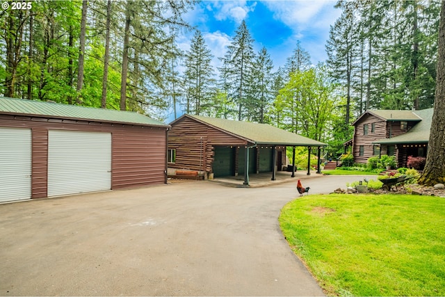 view of home's community featuring a garage and an outdoor structure
