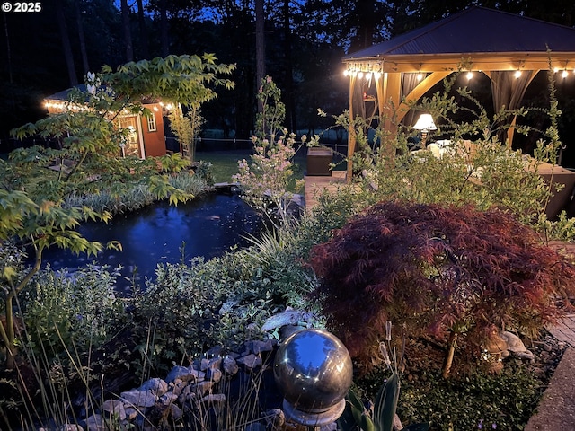 yard at twilight featuring a gazebo