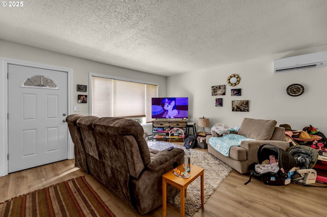 2117 Kauffman Ave, Vancouver, WA 98660 - living area featuring an AC wall unit, wood finished floors, and a textured ceiling