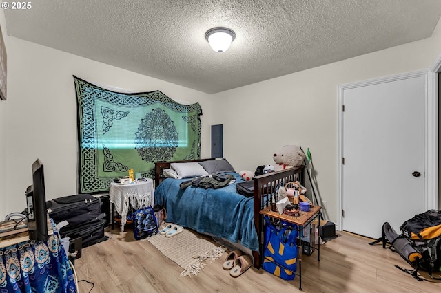 2117 Kauffman Ave, Vancouver, WA 98660 - bedroom featuring wood finished floors, a textured ceiling, and electric panel