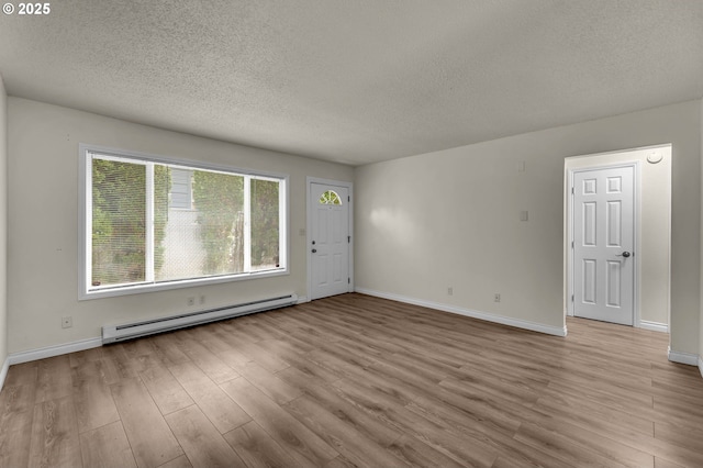 2117 Kauffman Ave, Vancouver, WA 98660 - empty room with baseboard heating, a textured ceiling, wood finished floors, and baseboards