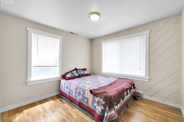 695 32nd St, Springfield, OR 97478 - bedroom with wood-type flooring and wood walls