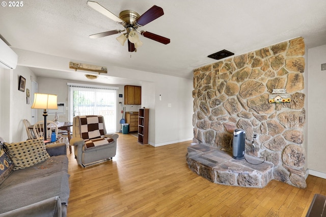 695 32nd St, Springfield, OR 97478 - living area with light wood-style flooring, ceiling fan, and a wood stove
