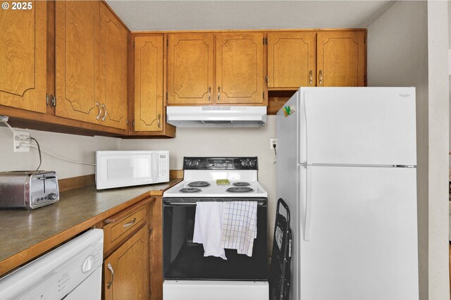 695 32nd St, Springfield, OR 97478 - kitchen with white appliances, under cabinet range hood, brown cabinets, and dark countertops