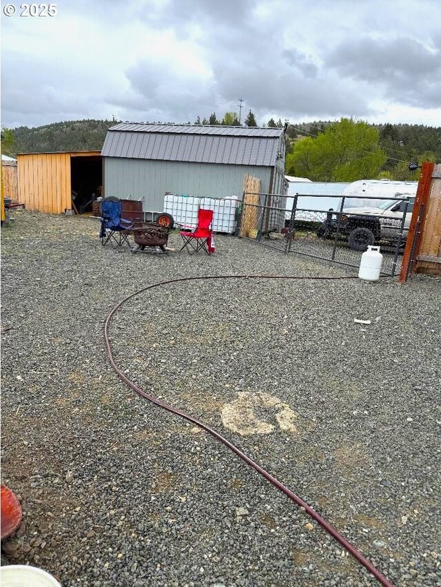 view of yard with fence and an outbuilding