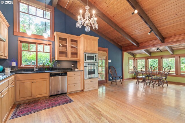 86595 N Modesto Dr, Eugene, OR 97402 - kitchen featuring track lighting, stainless steel appliances, a sink, light wood-style floors, and dark countertops