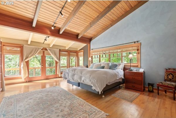 86595 N Modesto Dr, Eugene, OR 97402 - bedroom featuring wood finished floors, wooden ceiling with exposed beams, high vaulted ceiling, and french doors
