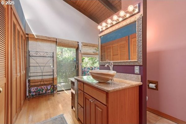 86595 N Modesto Dr, Eugene, OR 97402 - bathroom featuring vanity, wood ceiling with exposed beams, wood finished floors, high vaulted ceiling, and toilet