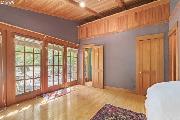 86595 N Modesto Dr, Eugene, OR 97402 - bedroom featuring french doors, wooden ceiling with exposed beams, wood finished floors, and baseboards