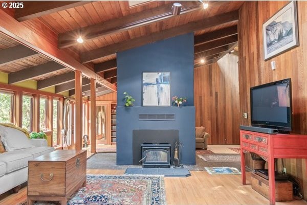 86595 N Modesto Dr, Eugene, OR 97402 - living area featuring wooden ceiling, wood walls, a wood stove, and wood finished floors