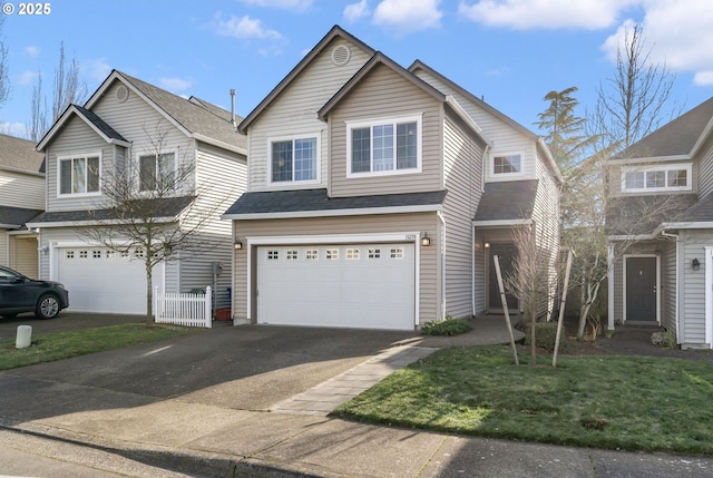 view of front of house featuring a front yard and a garage