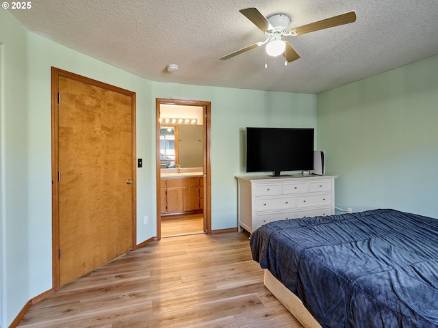 1201 Meadow Dr, Molalla, OR 97038 - bedroom with light wood-type flooring, a textured ceiling, connected bathroom, and ceiling fan