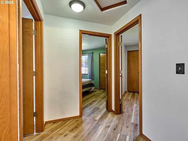 1201 Meadow Dr, Molalla, OR 97038 - hall featuring light wood-style flooring, attic access, and a textured ceiling