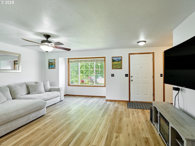 1201 Meadow Dr, Molalla, OR 97038 - living room with light wood-style flooring, ceiling fan, and a textured ceiling