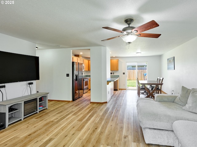 1201 Meadow Dr, Molalla, OR 97038 - living room with ceiling fan, light wood-style floors, and a textured ceiling