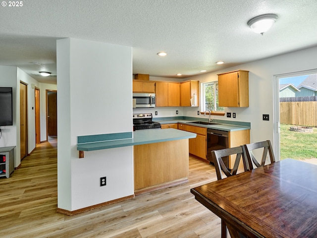 1201 Meadow Dr, Molalla, OR 97038 - kitchen with electric range, stainless steel microwave, light wood finished floors, dishwashing machine, and a textured ceiling