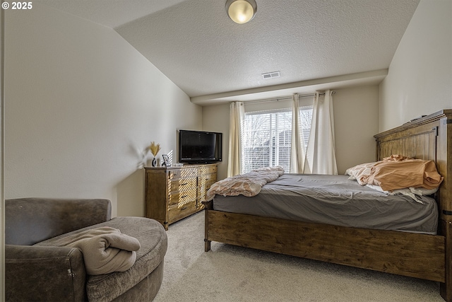 bedroom featuring lofted ceiling, light colored carpet, and a textured ceiling