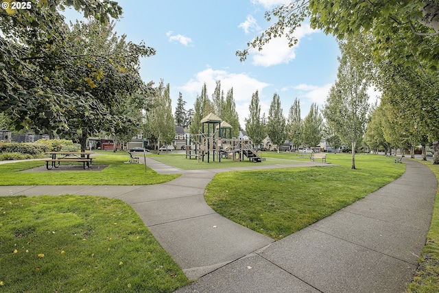 surrounding community with a lawn and a playground