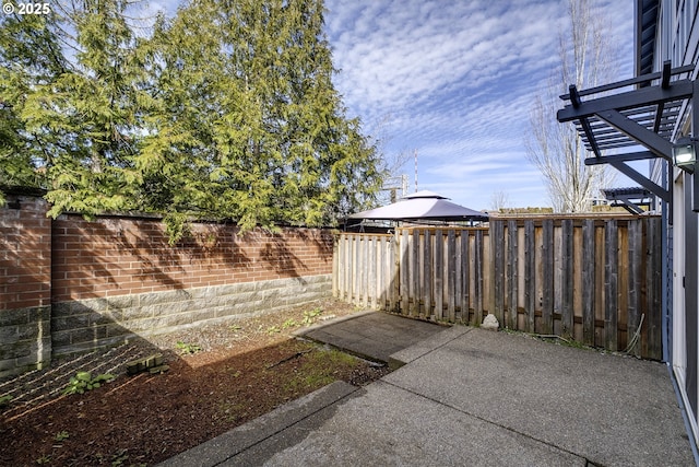 view of yard with a patio area, a fenced backyard, and a gazebo