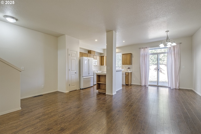 unfurnished living room with dark wood-style floors, baseboards, and a chandelier