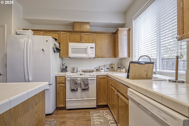 kitchen with white appliances, tile countertops, and dark wood-type flooring