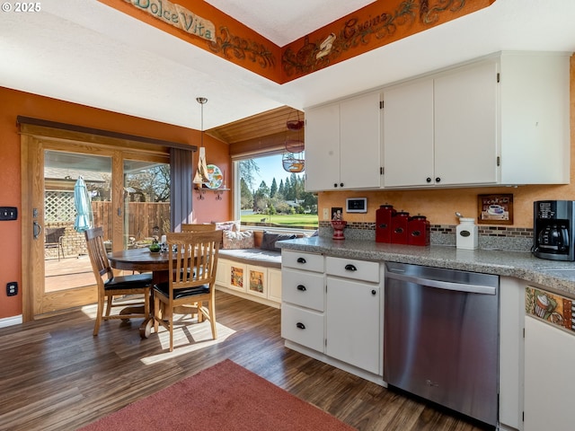 kitchen with decorative light fixtures, stainless steel dishwasher, dark wood-style floors, and white cabinets