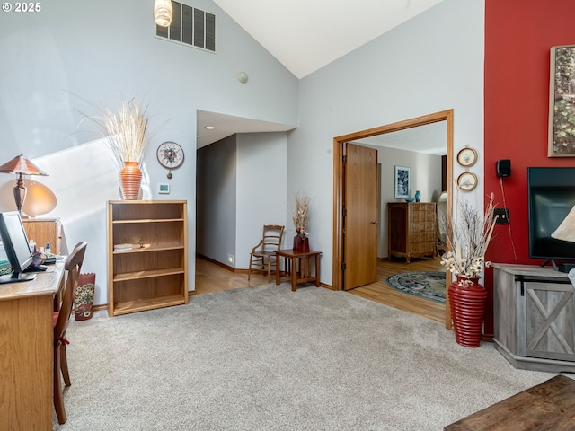 interior space featuring baseboards, visible vents, carpet floors, and high vaulted ceiling