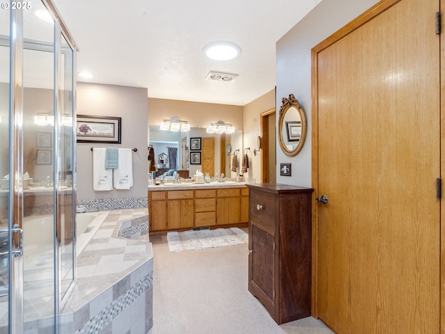 bathroom featuring a bath, visible vents, a stall shower, and vanity