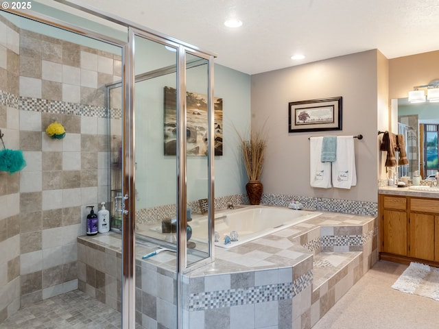 full bathroom with recessed lighting, a shower stall, vanity, and a garden tub