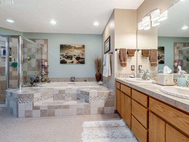 bathroom with a bath, a shower stall, double vanity, and a sink