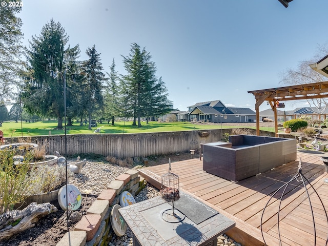 wooden deck with a residential view, a pergola, and a fenced backyard