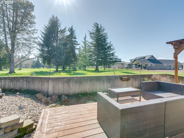 wooden terrace featuring an outdoor hangout area and a fenced backyard