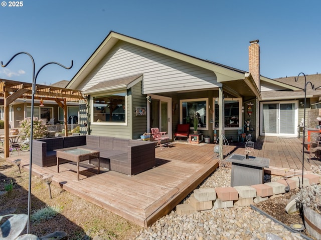 rear view of property featuring a deck, a pergola, and an outdoor hangout area