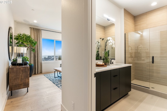 bathroom with vanity and a shower with door