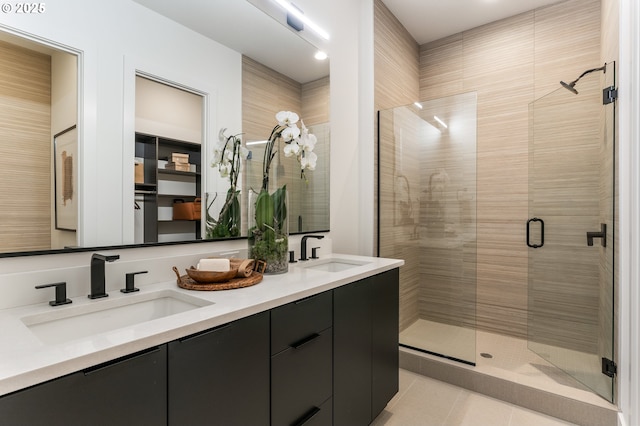 bathroom featuring tile patterned floors, vanity, and a shower with door