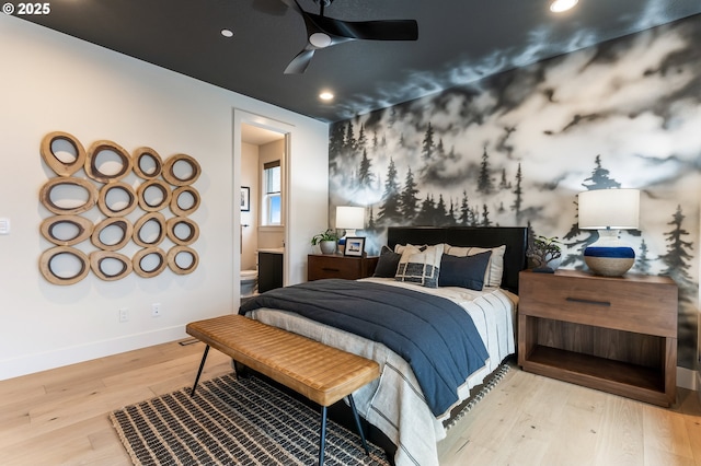 bedroom featuring light wood-type flooring, ensuite bath, and ceiling fan