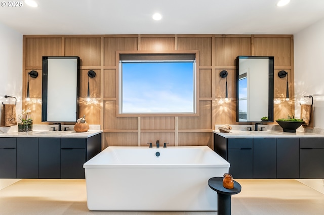 bathroom featuring vanity and a tub to relax in