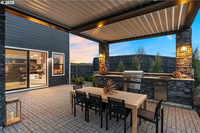 patio terrace at dusk with area for grilling and grilling area