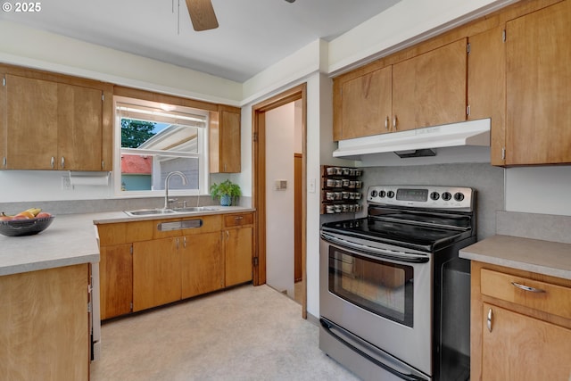 13015 E Burnside St, Portland, OR 97233 - kitchen featuring electric range, under cabinet range hood, light countertops, ceiling fan, and brown cabinetry