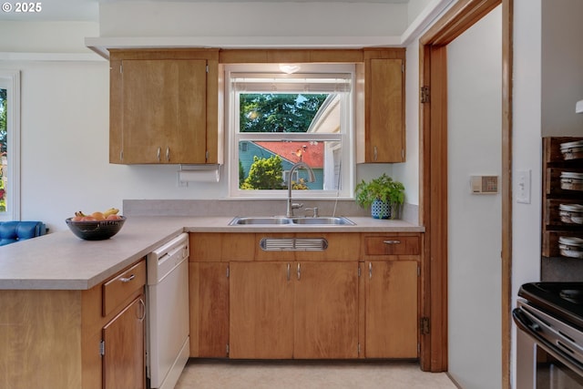 13015 E Burnside St, Portland, OR 97233 - kitchen with dishwasher, light countertops, a peninsula, and brown cabinets