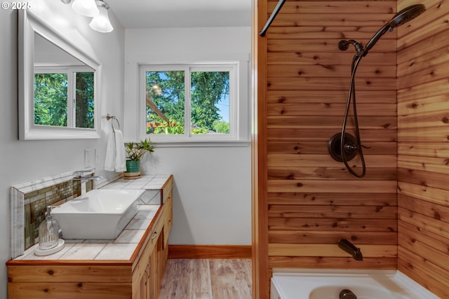 13015 E Burnside St, Portland, OR 97233 - bathroom featuring vanity, wood finished floors, and bathing tub / shower combination